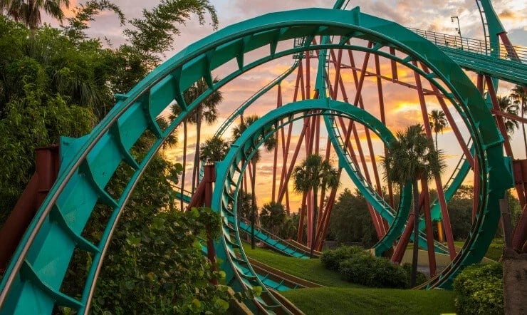 Kumba roller coaster loops at Busch Gardens Tampa Bay at sunset