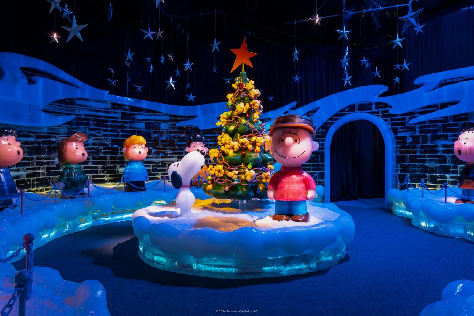 Charlie Brown and Snoopy ice sculptures with rotating Christmas tree