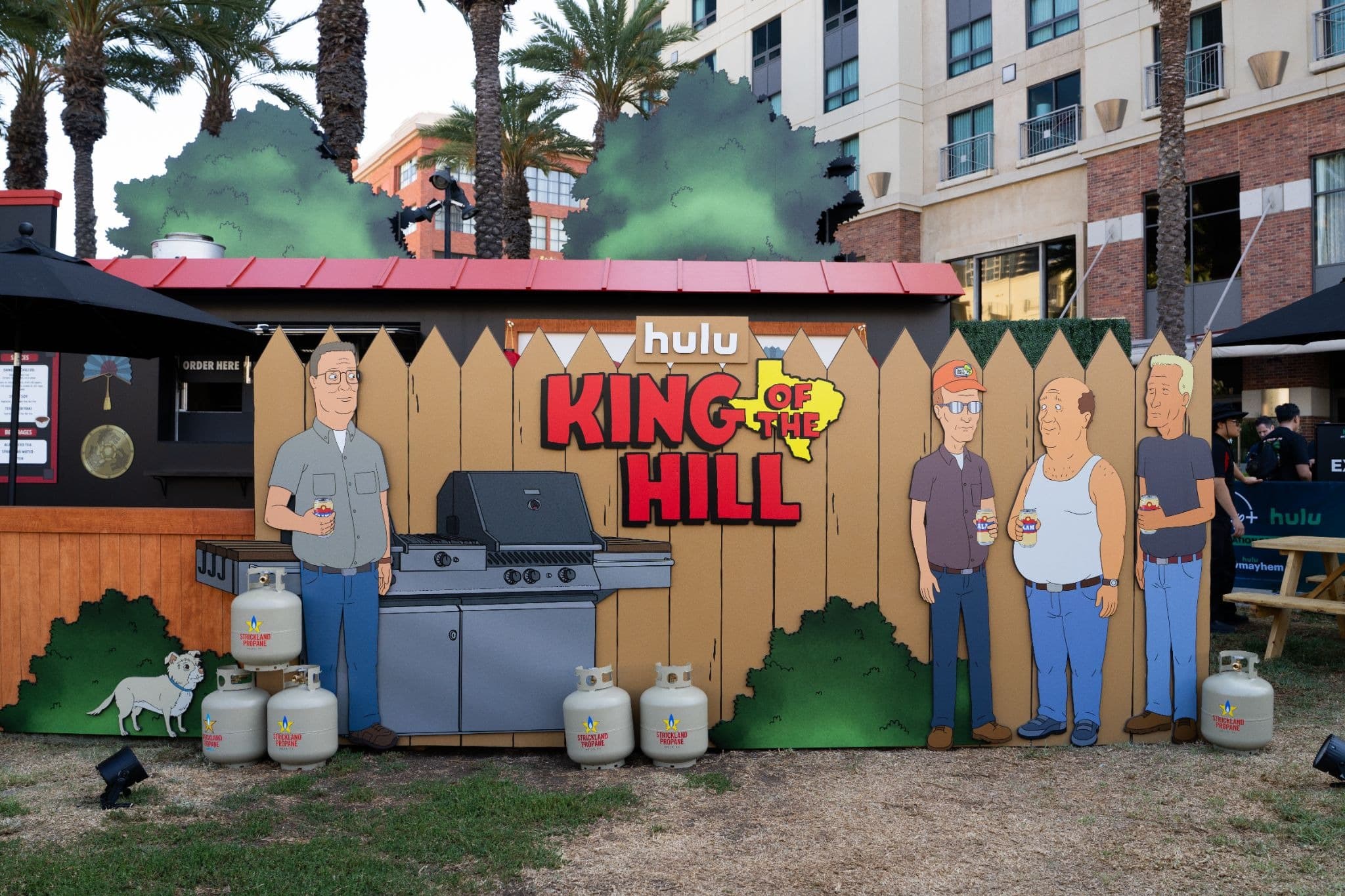 King of the Hill photo op with Hank Hill at his grill at Hulu Animayhem Fandom Fuel Up