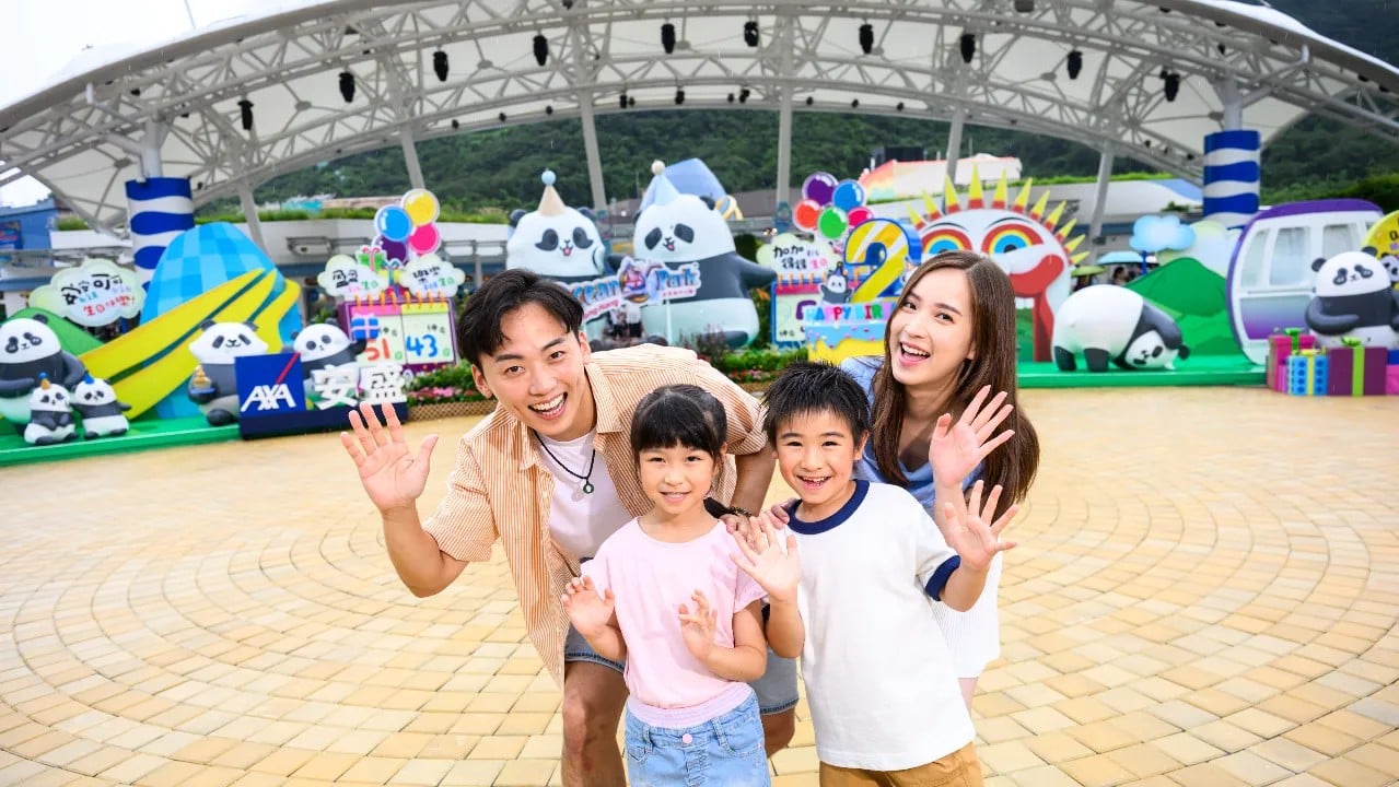 A family poses at a Panda Friends birthday photo spot at Ocean Park Hong Kong