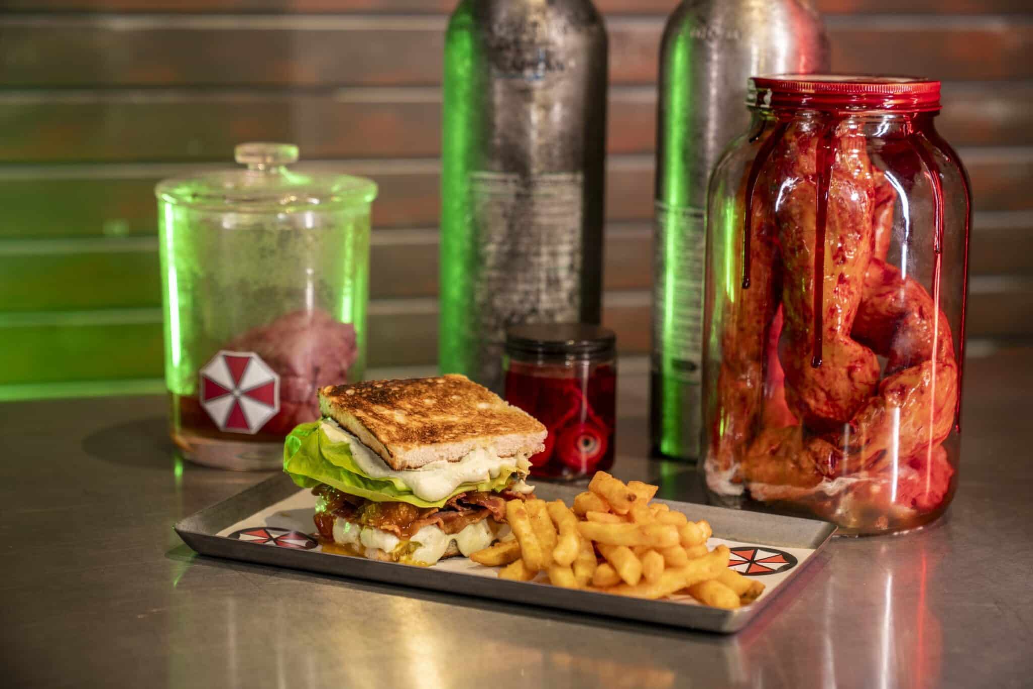 An Umbrella Corporation-themed sandwich and fries served among specimen jars at Universal Horror Unleashed's Resident Evil takeover.